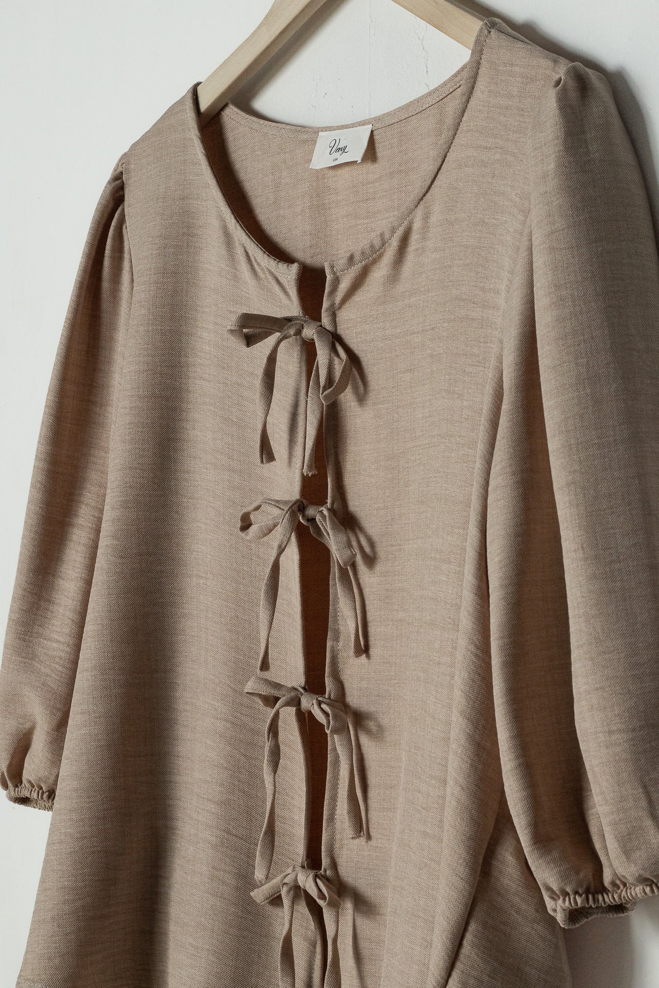 Blouse with beige bow