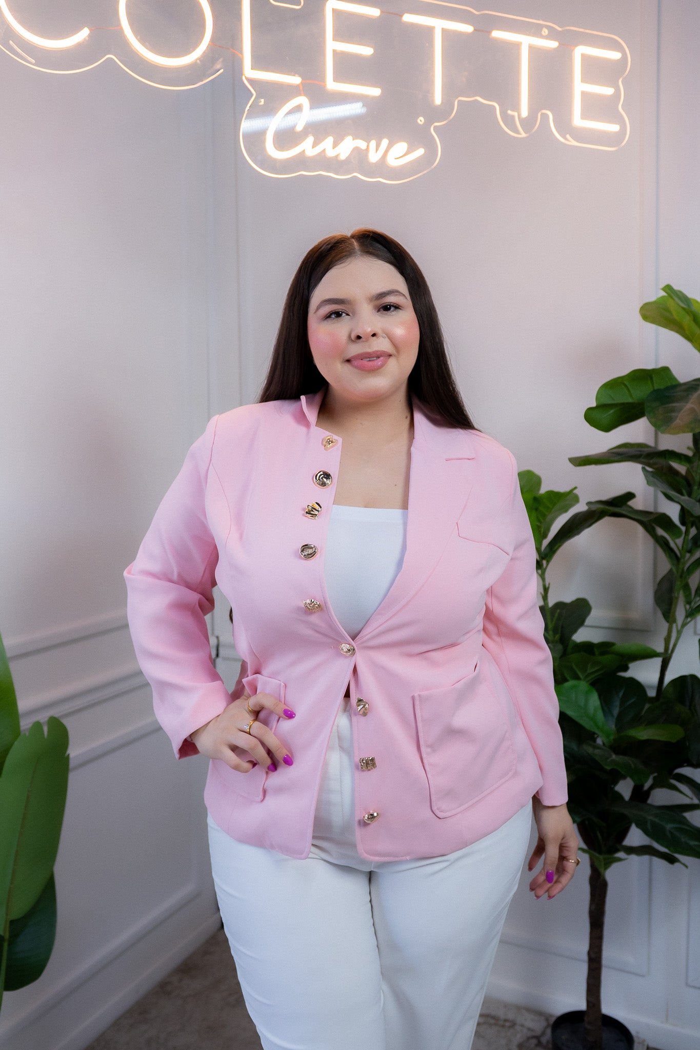 Modelo curvy usando blazer liso rosa con botones dorados que estructura silueta, talla extra plus size