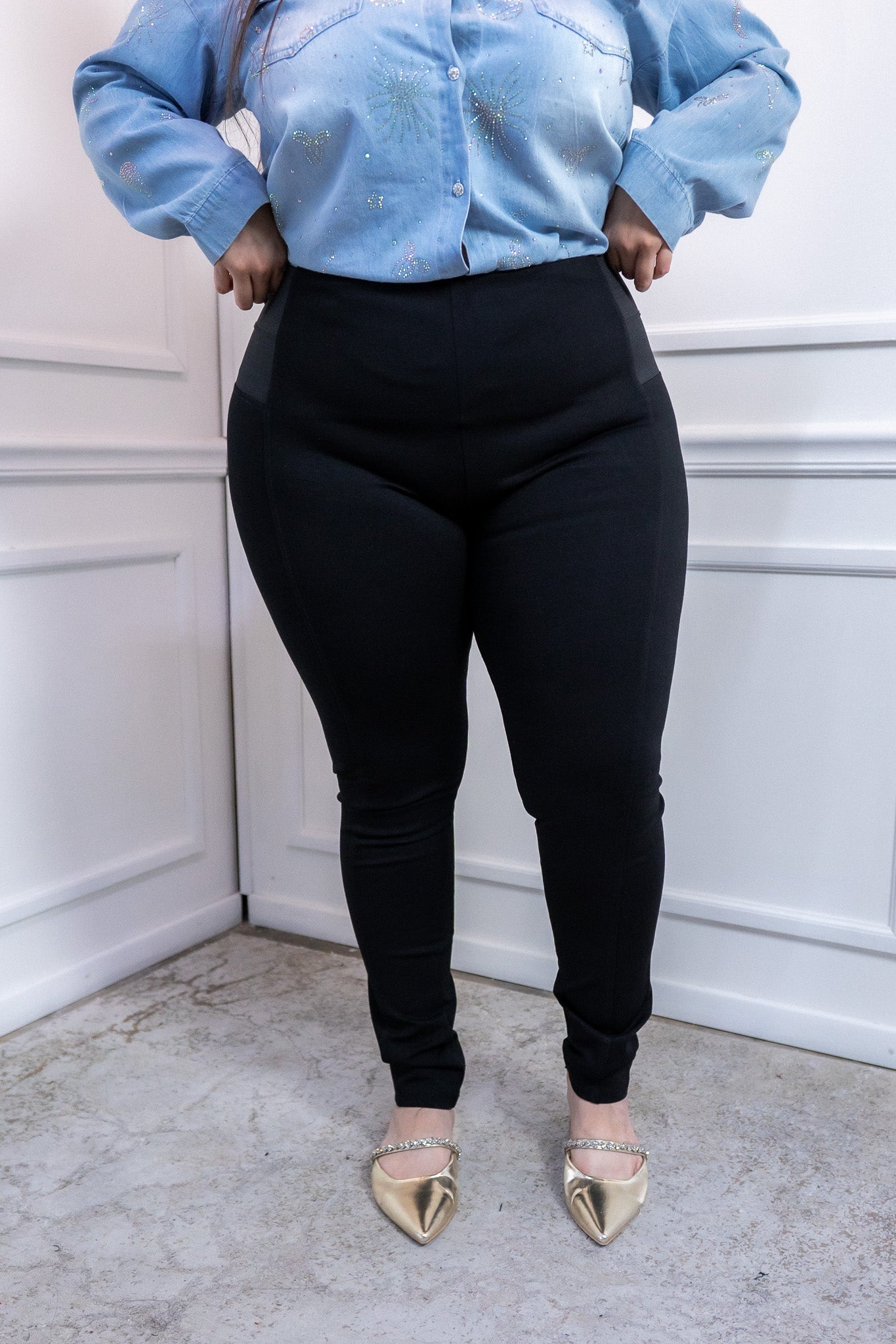 Modelo curvy usando pantalón tipo legging negro cintura alta con elástico lateral, talla extra plus size
